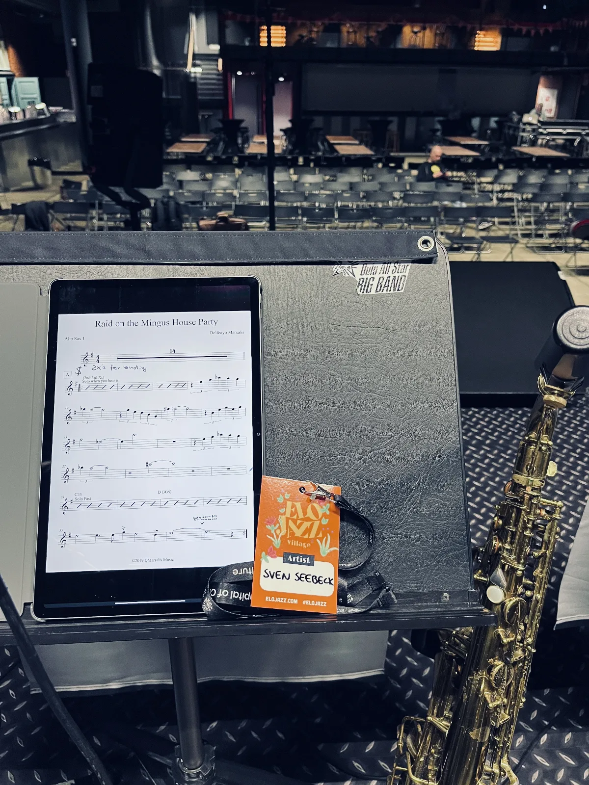 a picture of my music stand with an artist pass taken from the stage during soundcheck